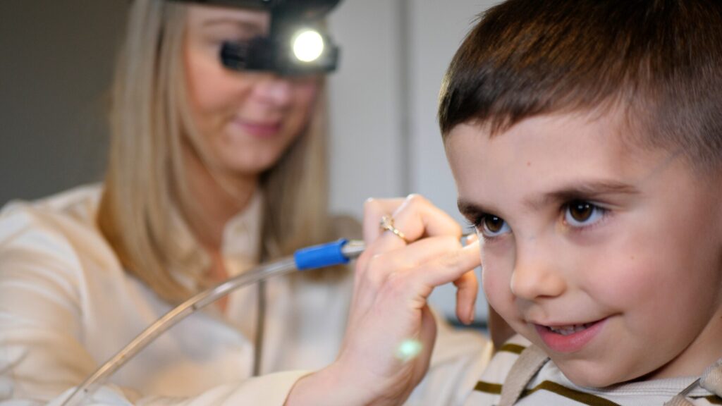 child getting ear wax removal procedure